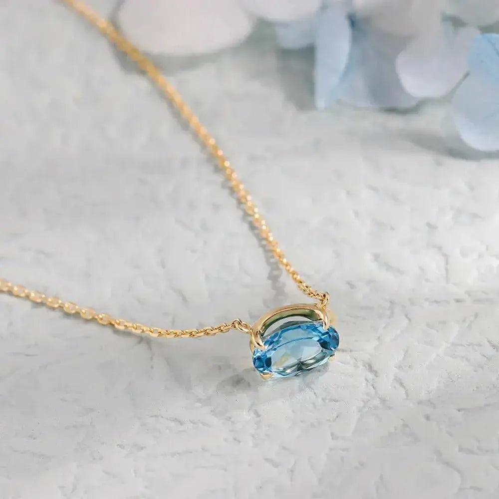 Modern Oval Blue Topaz Necklace in Solid Gold shop name